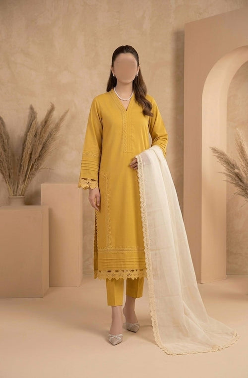 Person wearing a yellow traditional outfit with a white dupatta in a beige setting