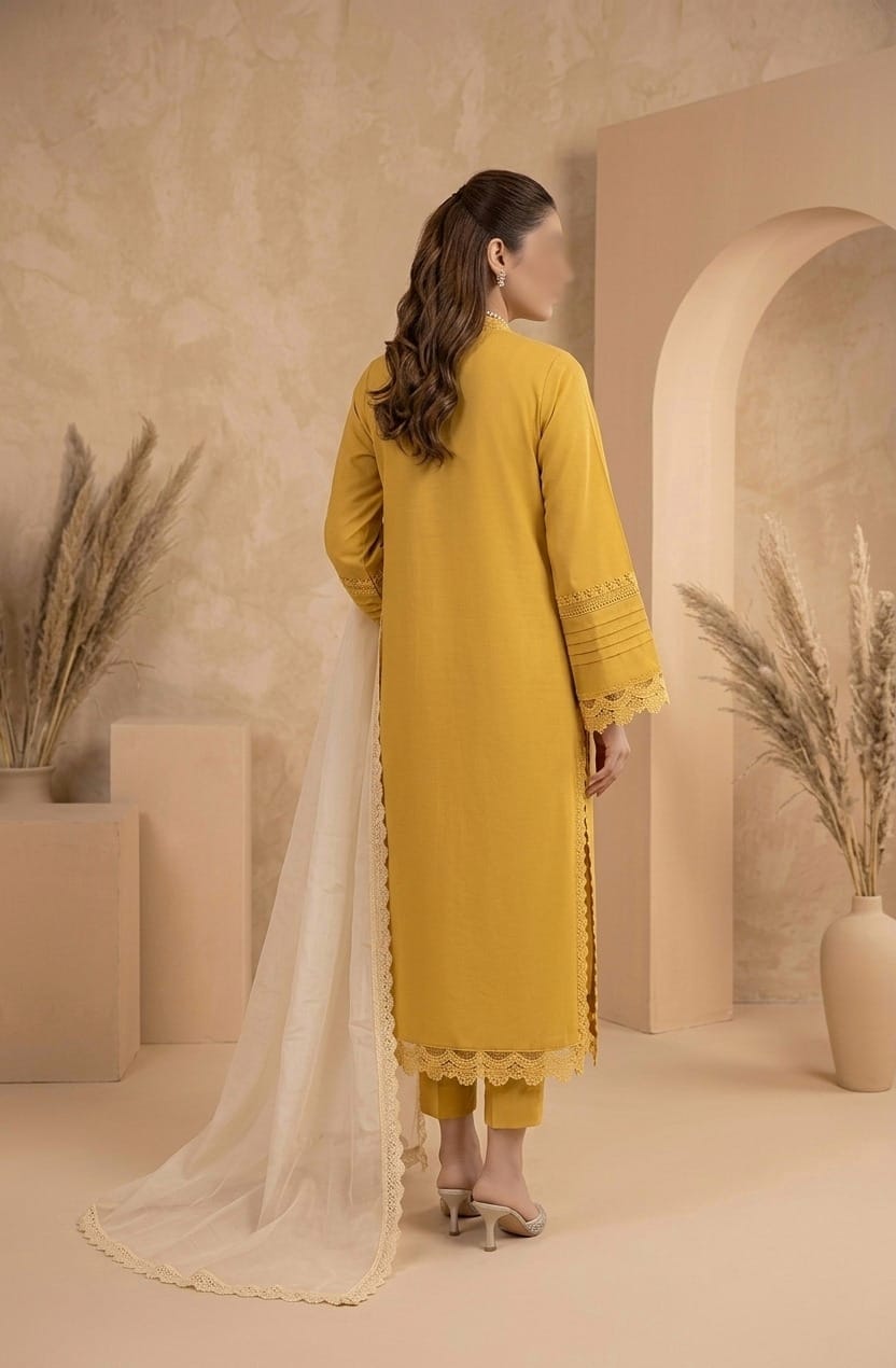 Woman in a yellow outfit standing in a neutral-colored room with decorative plants.